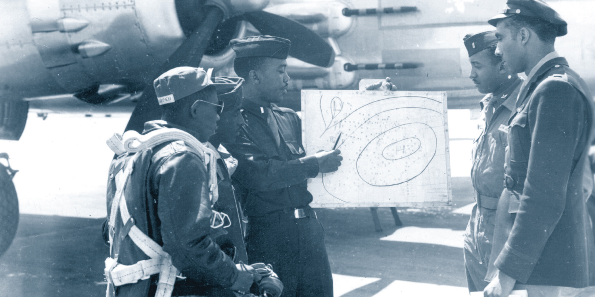 Tuskegee Airmen receiving a weather briefing