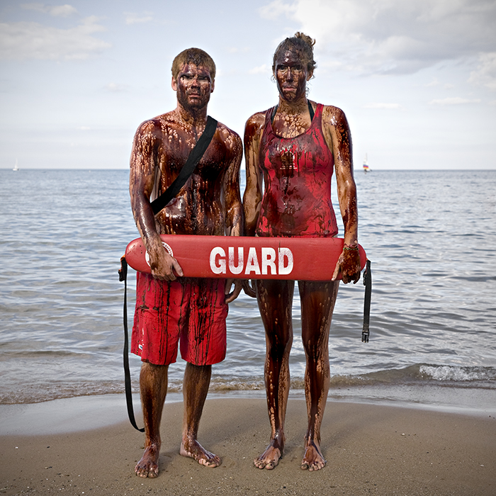 photo of lifeguards covered in oil