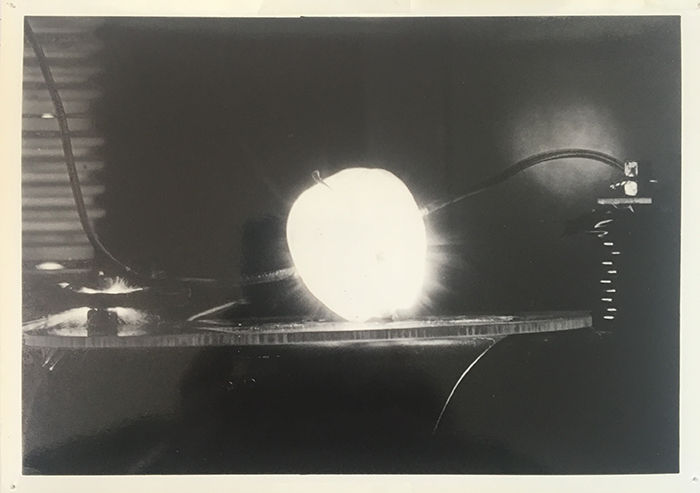 A photograph of an apple in the "destructotron"