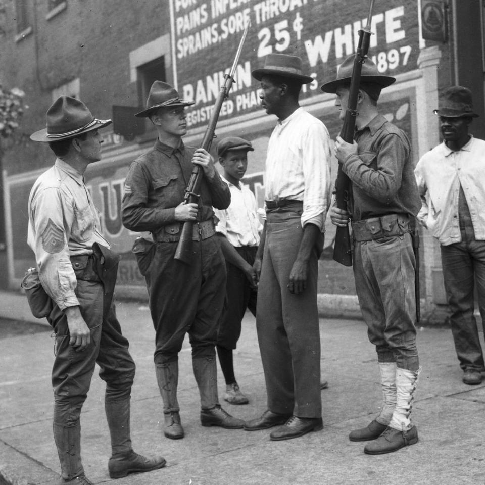 National Guard soldiers and African American men on a street corner in Chicago during the 1919 race riot