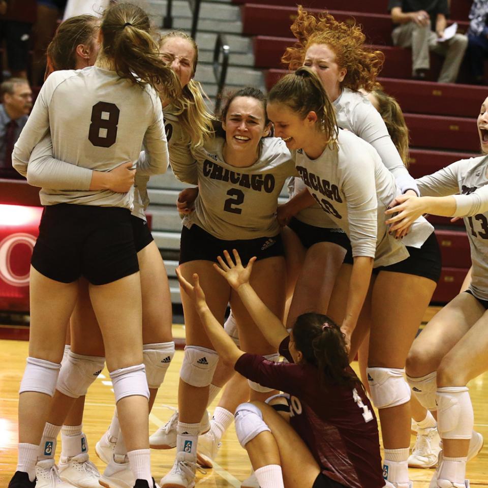 UChicago's women's volleyball team celebrating a win in 2019