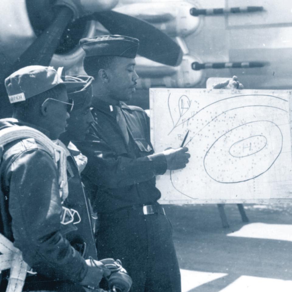 Tuskegee Airmen receiving a weather briefing