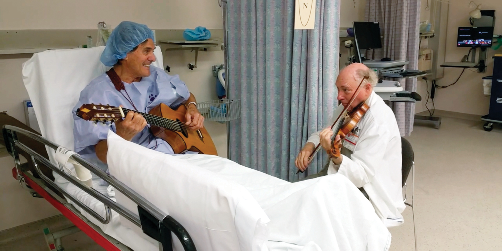 William Sloan and a patient playing a song before surgery