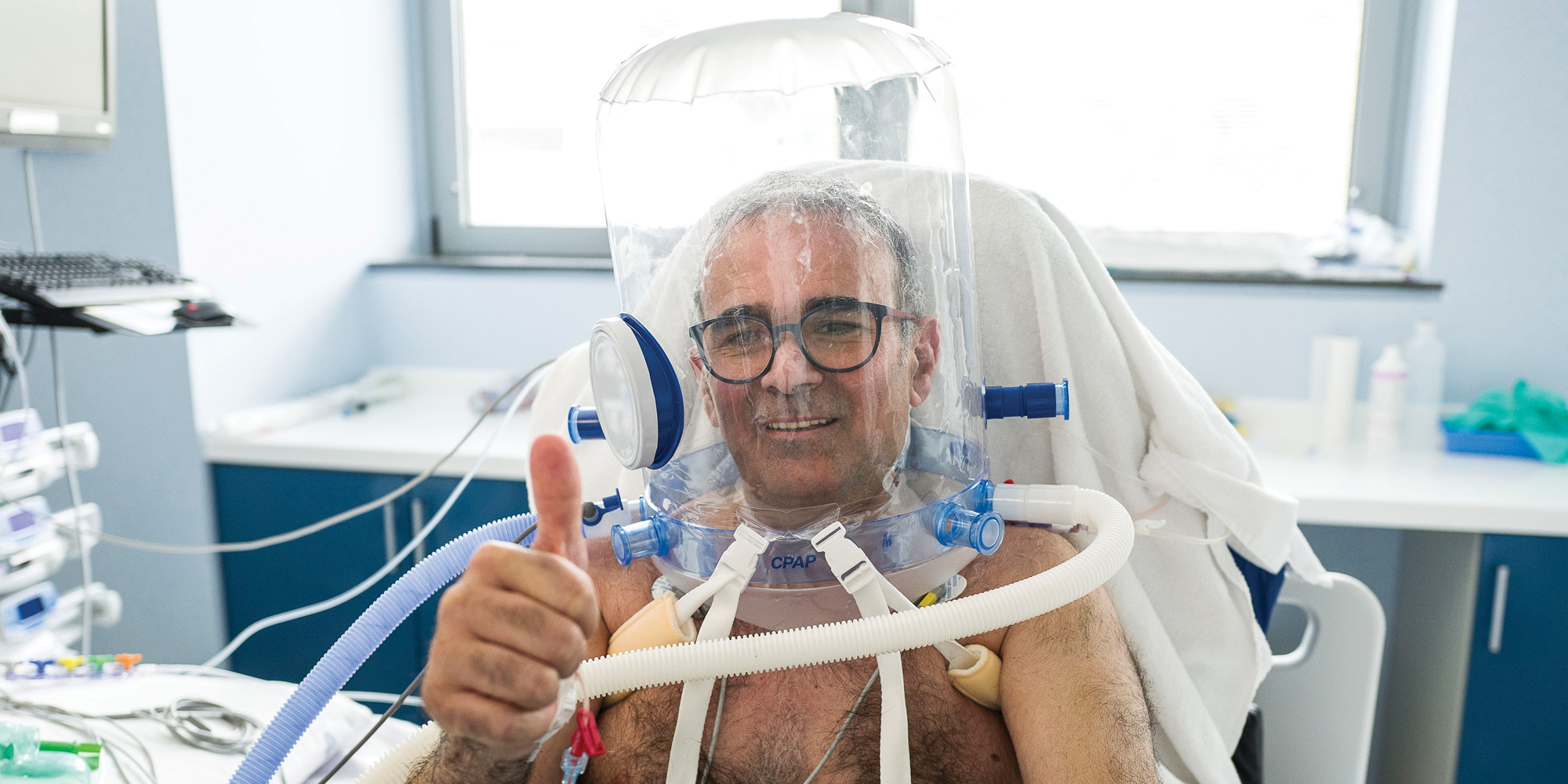 A patient in a ventilation helmet