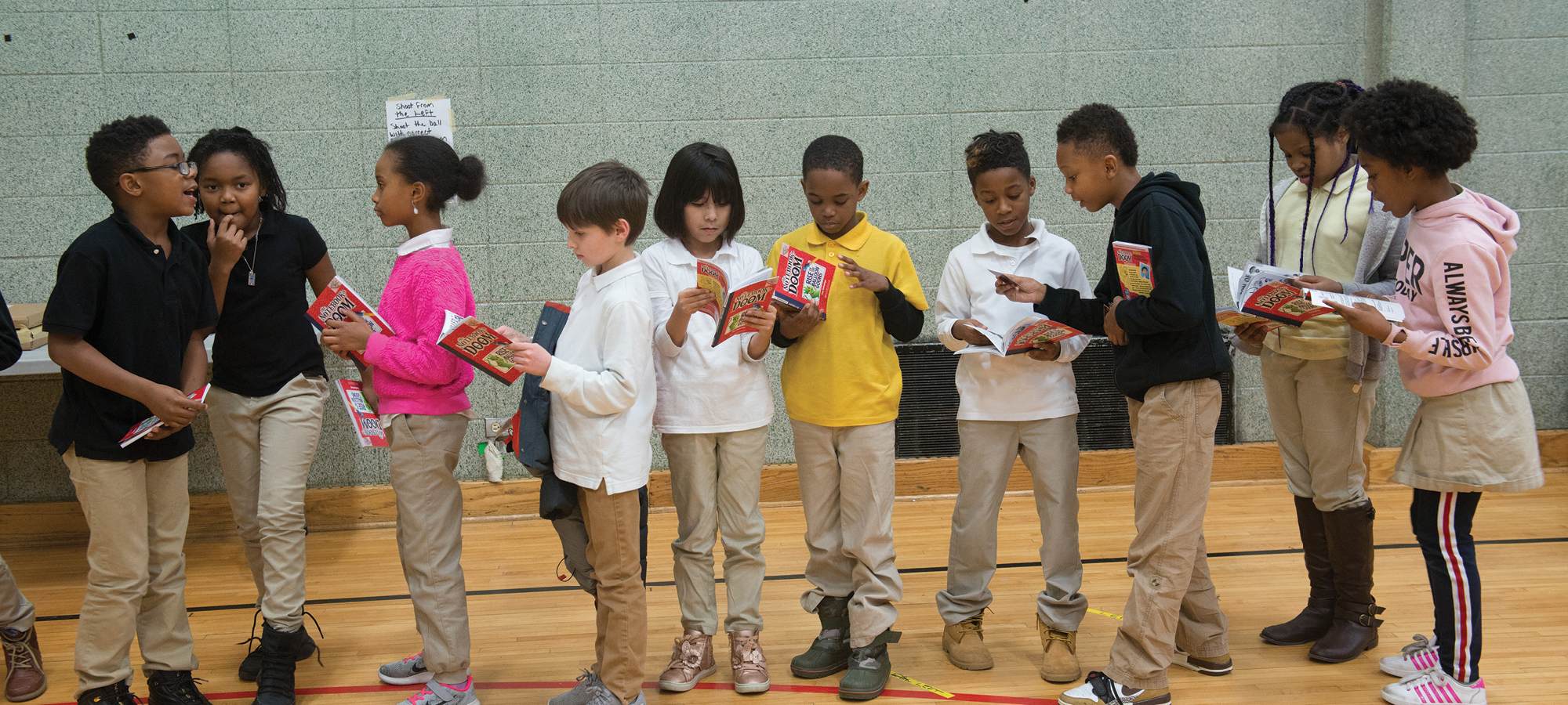 Students line up to meet author Troy Cummings