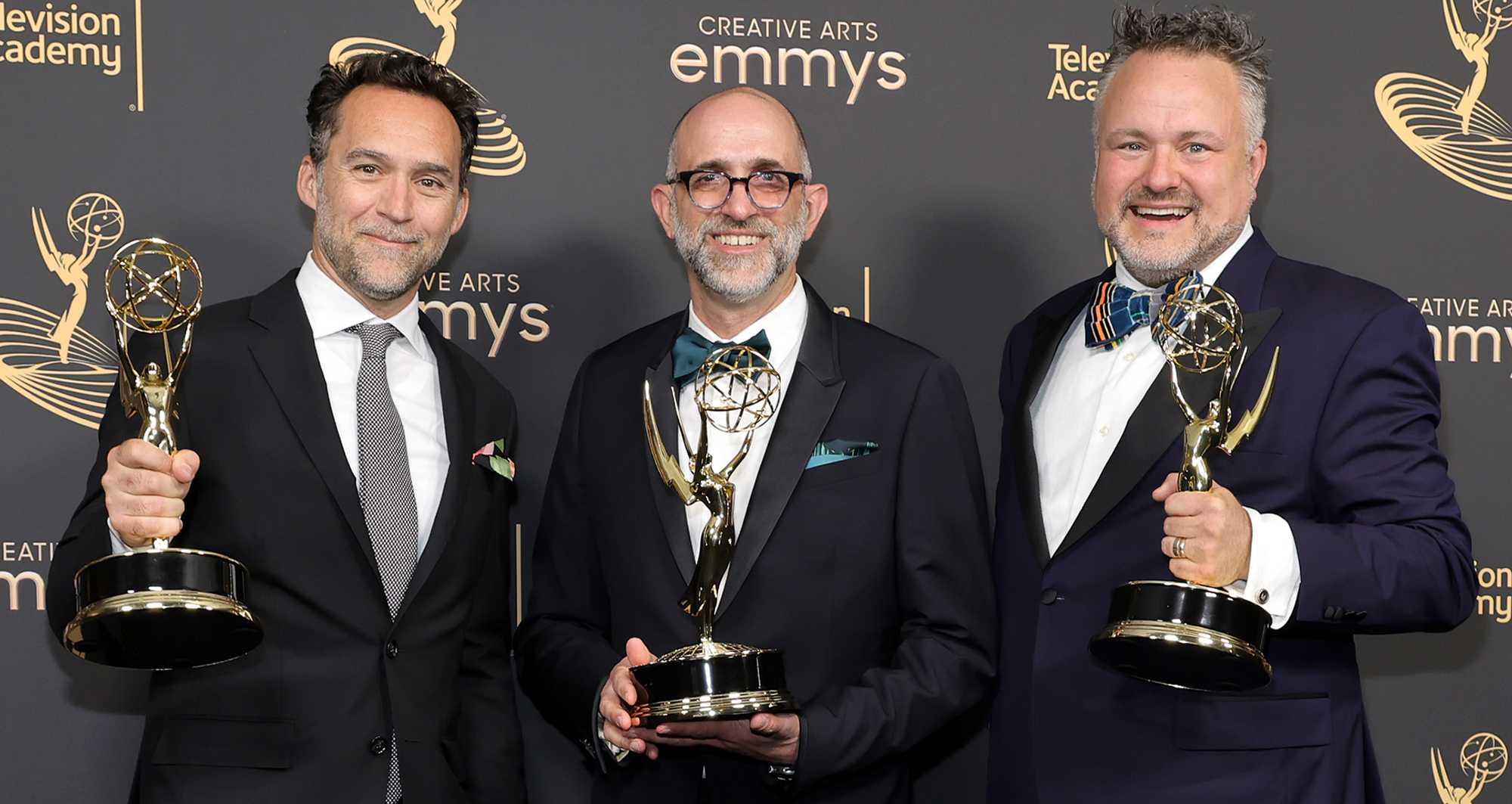 Production designer Curt Beech, art director Jordan Jacobs, and Rich Murray, AB’94, with their Emmys for Only Murders in the Building.