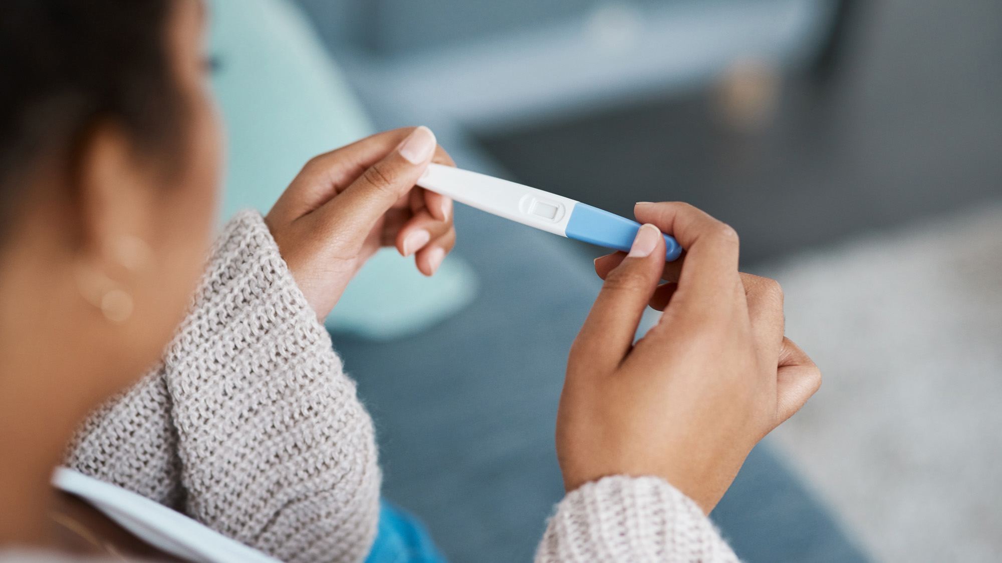 woman holding a pregnancy test stick