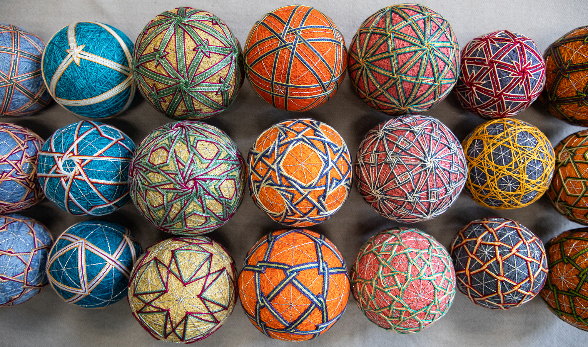 Colorful embroidered temari balls arranged in rows