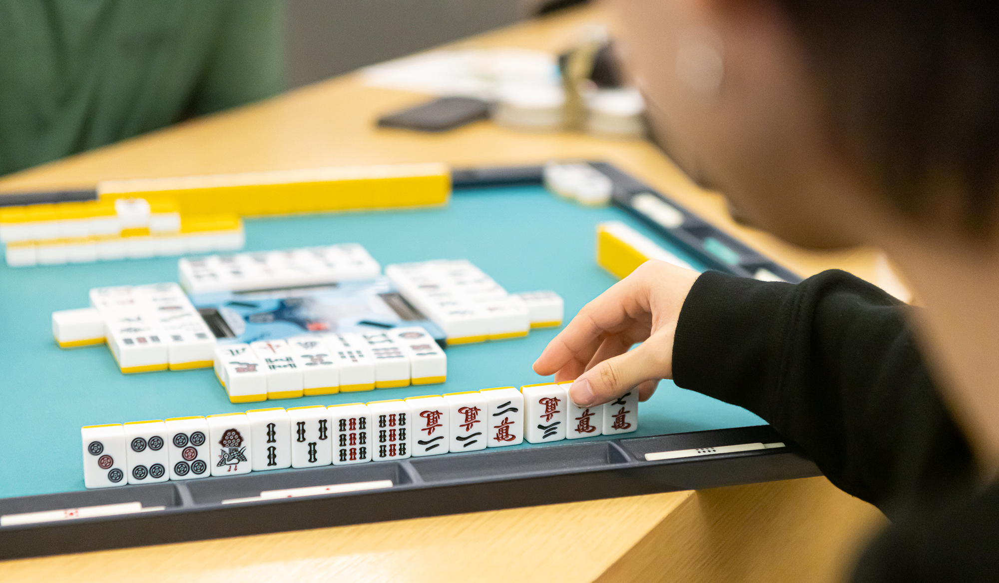 A student plays mah-jongg