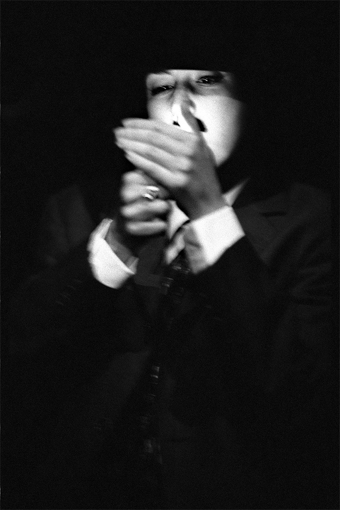 A drag king lighting a cigarette