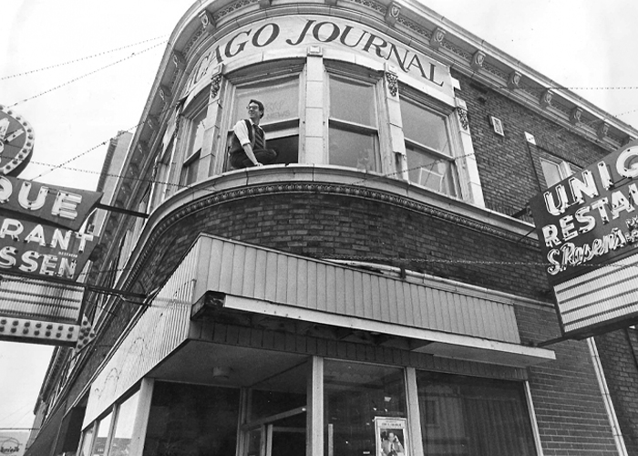 Chip Forrester in the window of the Chicago Journal offices on 53rd Street