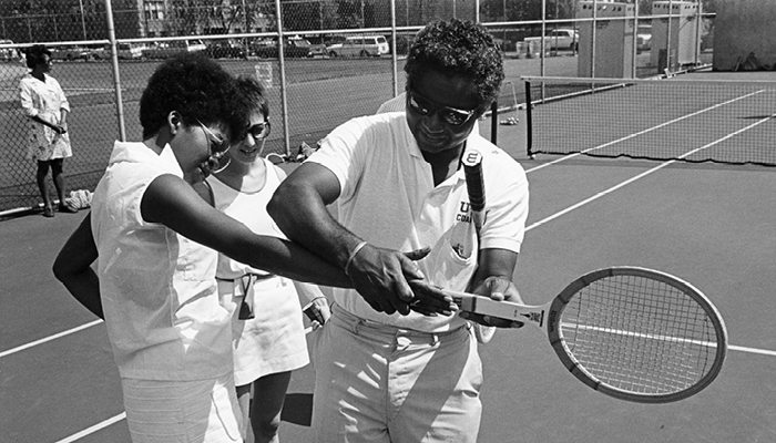 UChicago tennis coach Christopher Scott with students circa 1970
