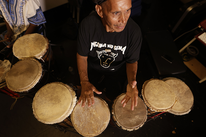 A drummer performs during class. 