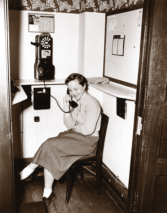 Woman in a dorm phone booth at UChicago in 1952