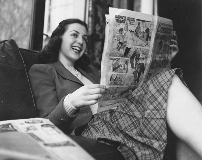 A young woman reading the funny papers in 1944