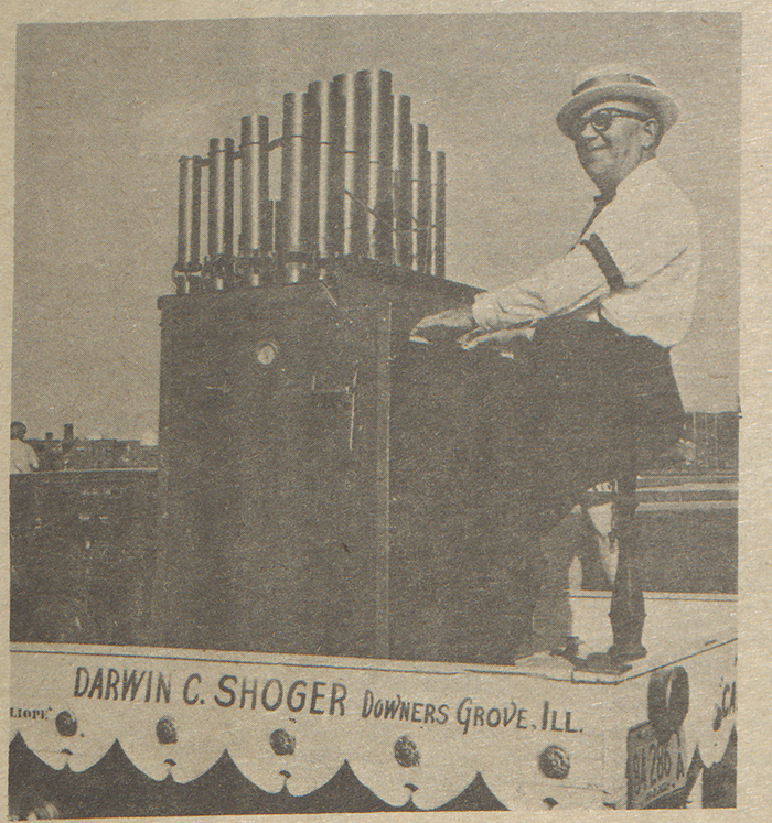 A newspaper clipping from the Maroon featuring Darwin C. Shoger playing a colliope during halftime