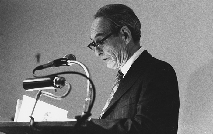 Norman Maclean at a lectern