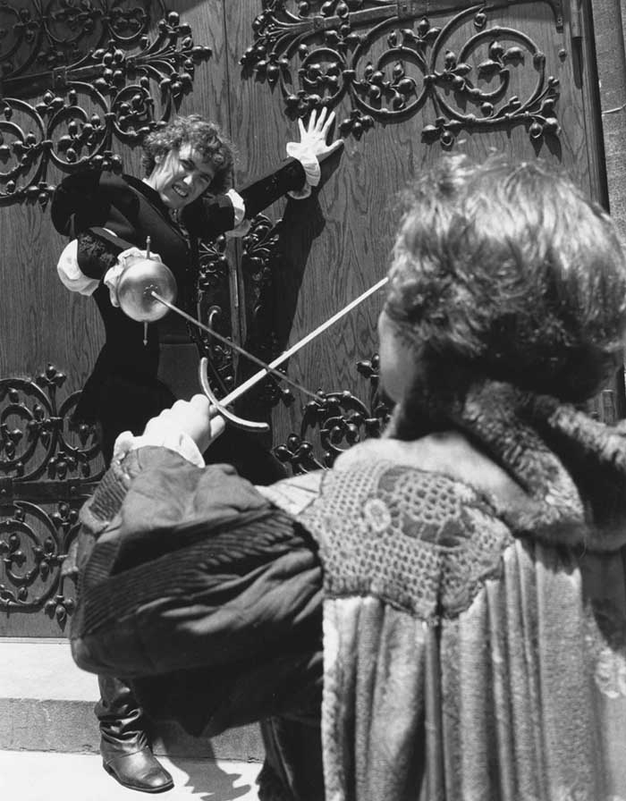 two actors in costume engaged in a sword fight from Hamlet