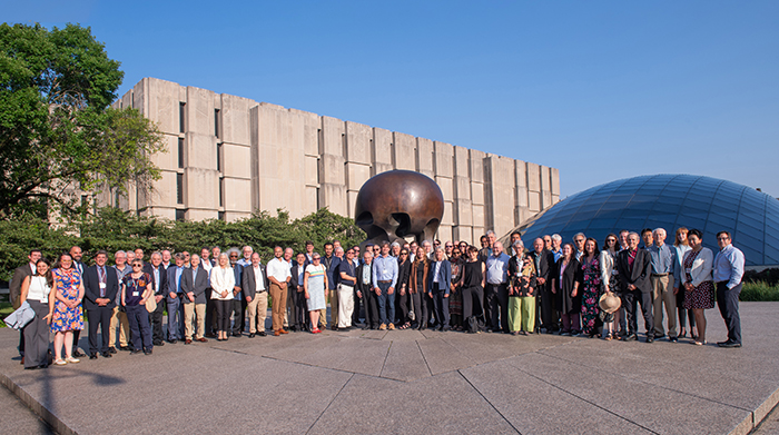 Attendees of the Nobel Laureate Assembly for the Prevention of Nuclear War stand by Henry Moore's "Nuclear Energy" sculpture on the University of Chicago campus