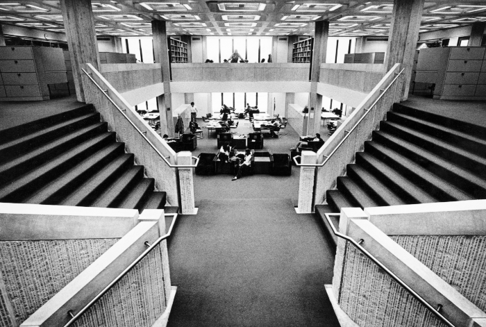 A B&W photo of the central stairs in UChicago's Regenstein Library.