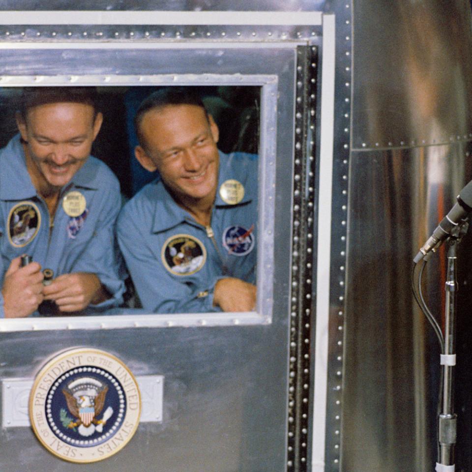 The Apollo 11 astronauts greet President Richard Nixon from quarantine
