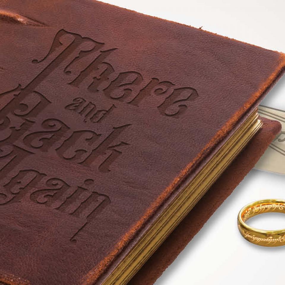 Book with leather cover embossed with “There and Back Again”