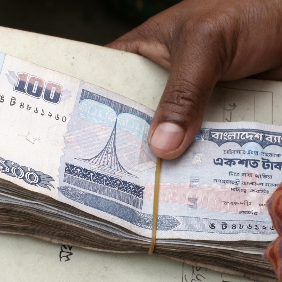 Grameen Bank borrower presents her loan repayment