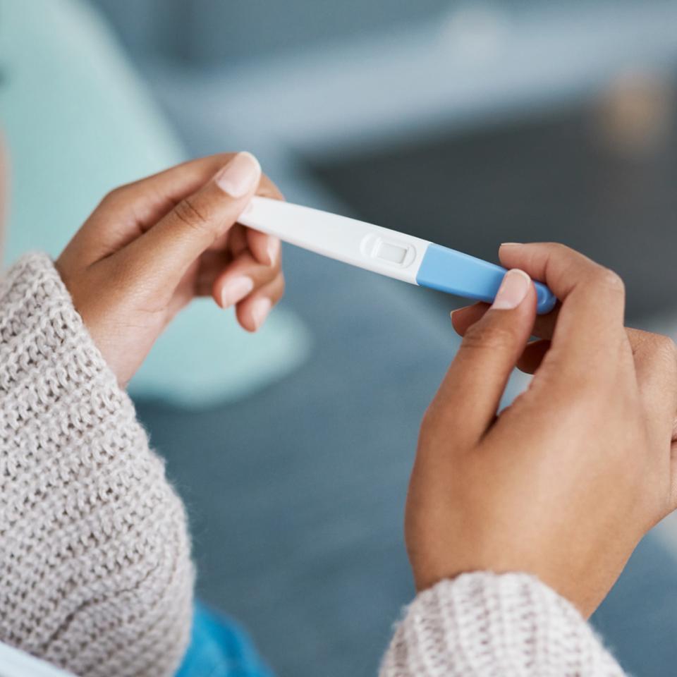 woman holding a pregnancy test stick