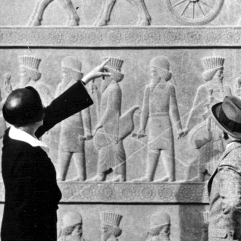 Frances Hart Breasted and her husband archaeologist James Henry Breasted study the Apadana stairway sculptured friezes at Persepolis.